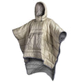 Ridge insulated poncho in khaki, hood up, showing the quilted panels and arm opening